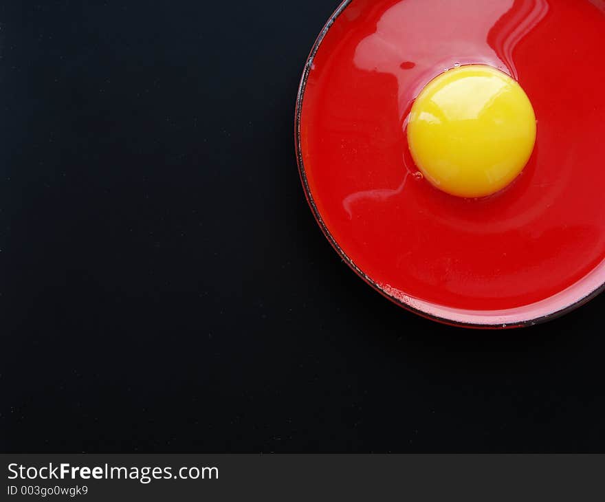 Still life with egg on red and black colours. Still life with egg on red and black colours