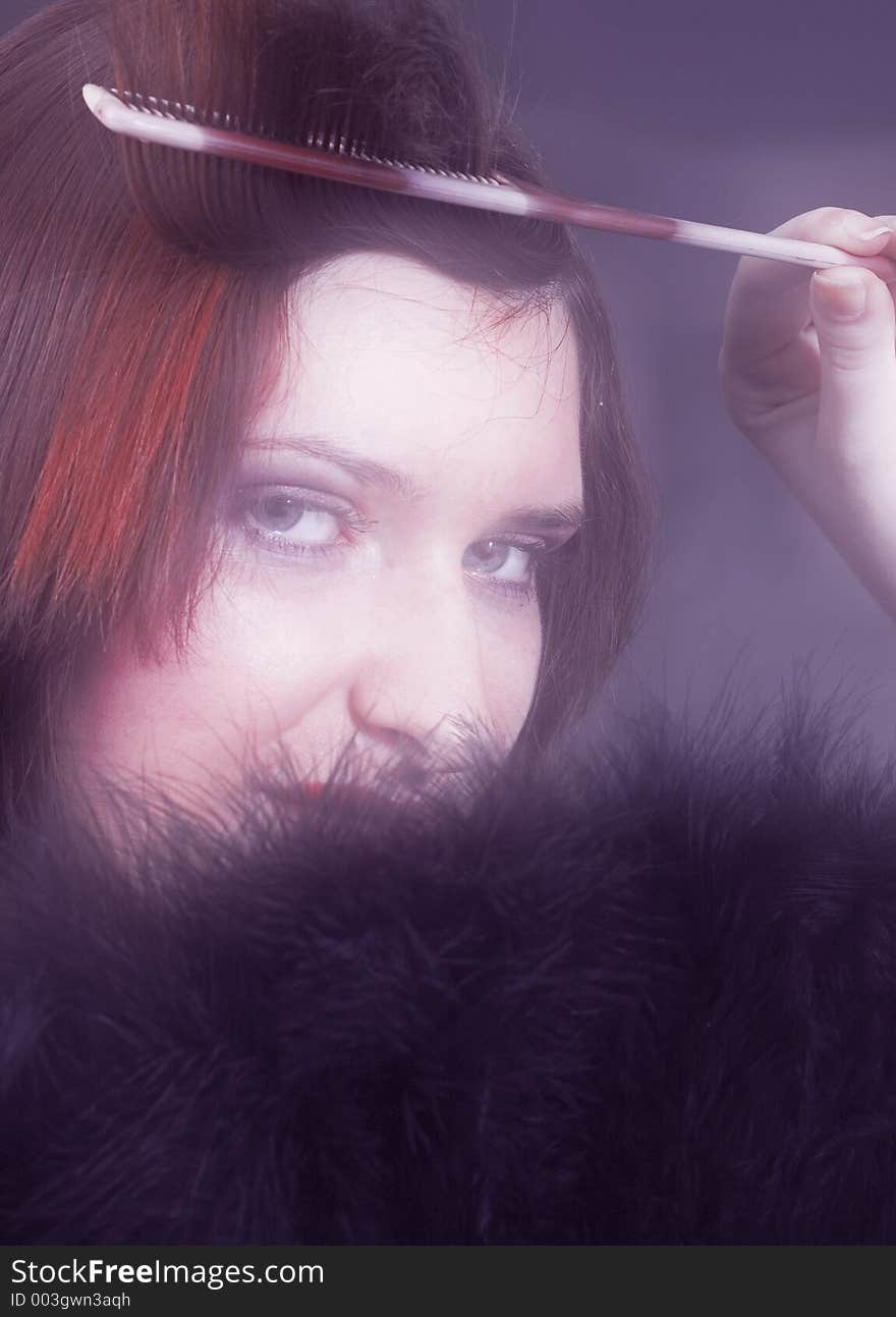 Young woman creating a hair style, soft focus