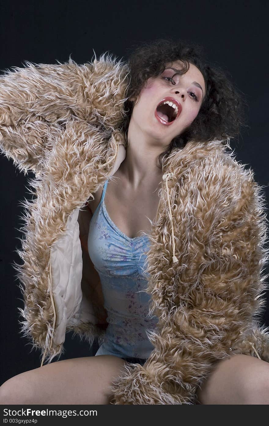 Young woman in fur coat going wild. Young woman in fur coat going wild