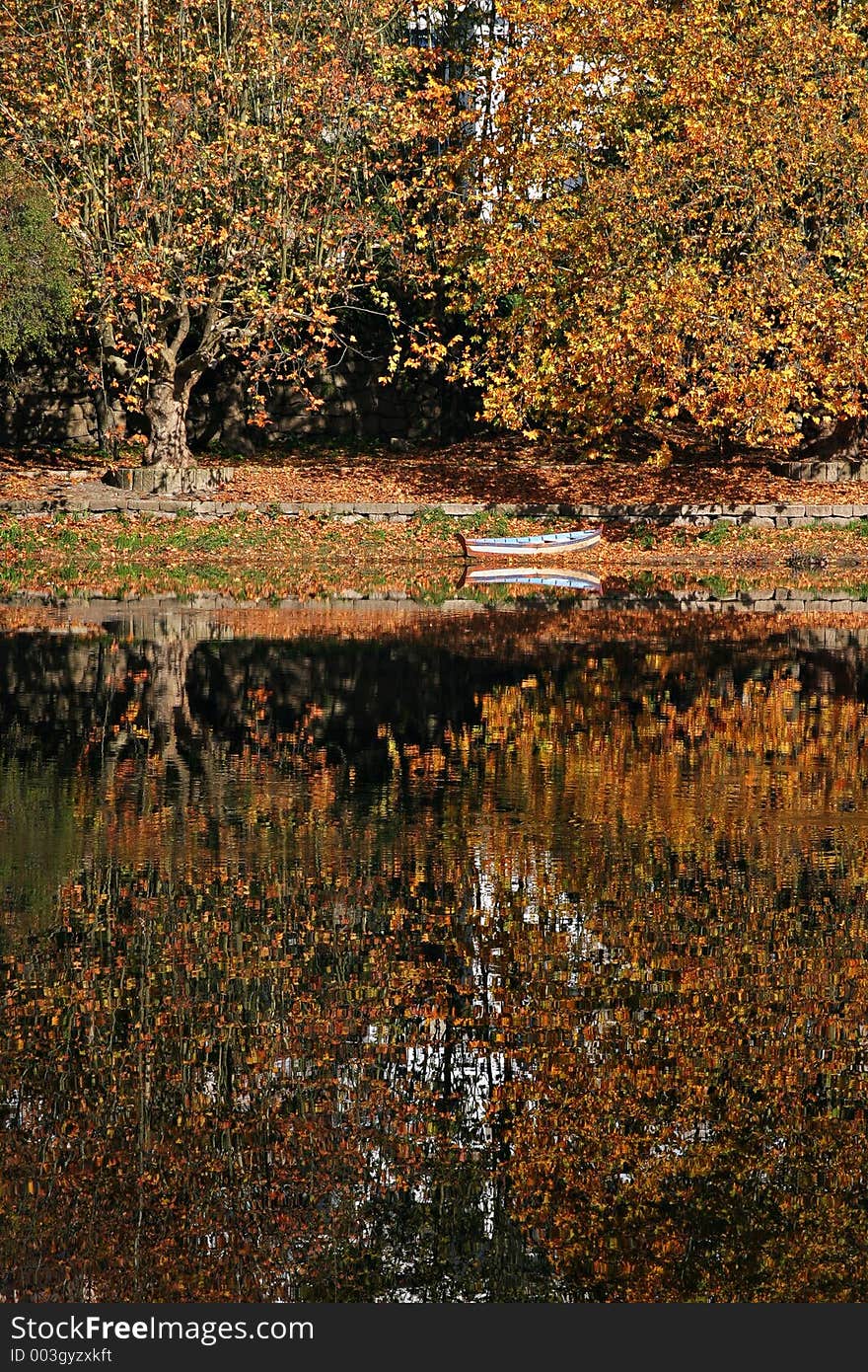 Boat and reflection in autumn scene