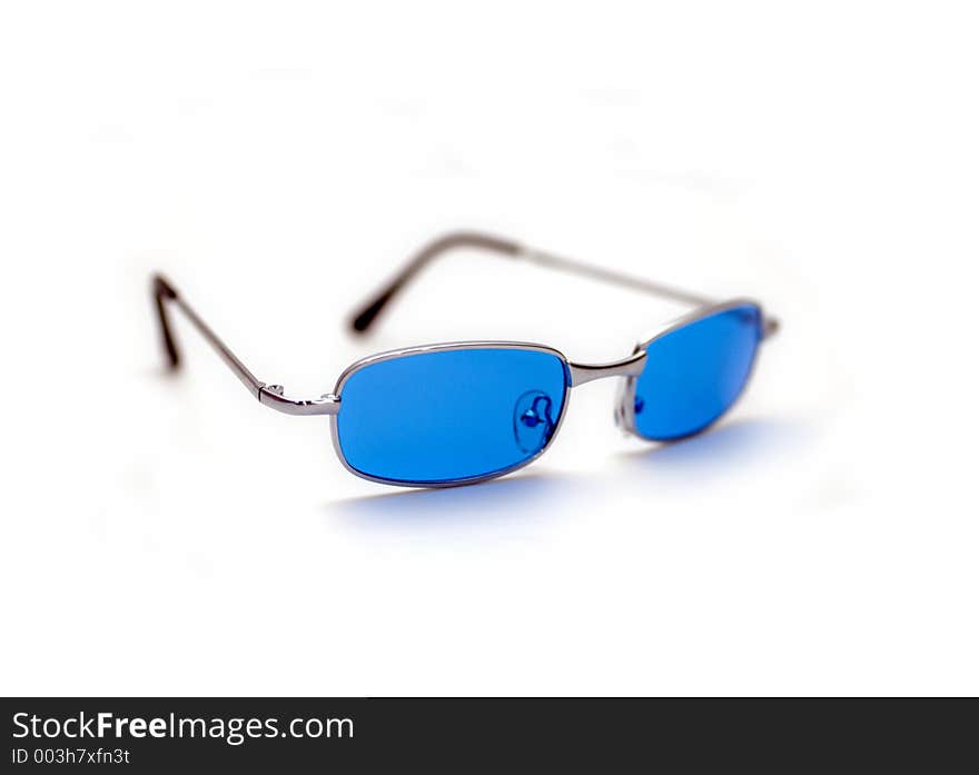 A pair of blue/silver sunglasses isolated against a white background. A pair of blue/silver sunglasses isolated against a white background.