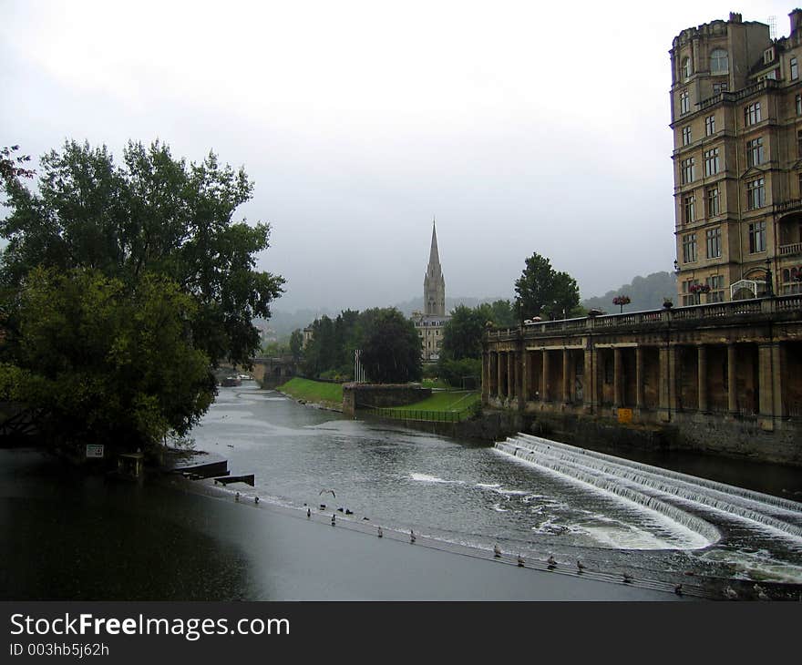 River and waterfall, bath, england on cloudy day