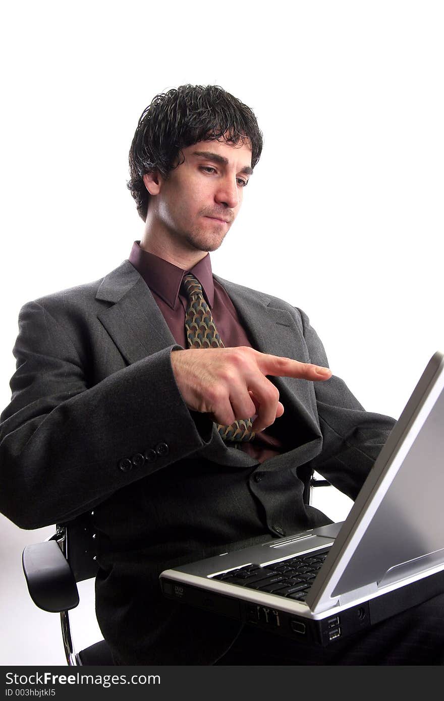 Businessman working on laptop pointing finger