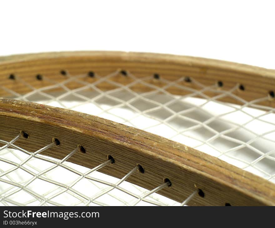 The bindings of the strings on wooden badminton rackets. Very old rackets. Shallow depth of field. Focus on the frame of the racket where the binding is. The bindings of the strings on wooden badminton rackets. Very old rackets. Shallow depth of field. Focus on the frame of the racket where the binding is.