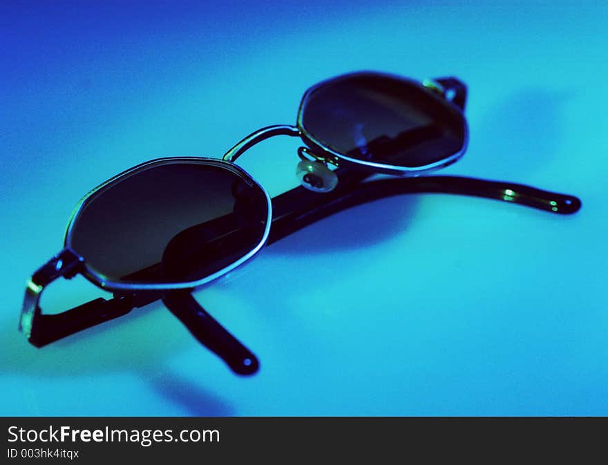 Sunglasses on blue background