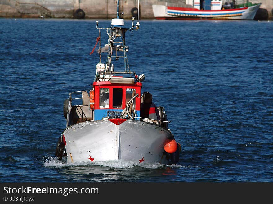 Boat returning from fishes in harbor