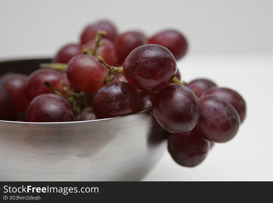 Red grapes in a silver bowl cropped shot. Red grapes in a silver bowl cropped shot