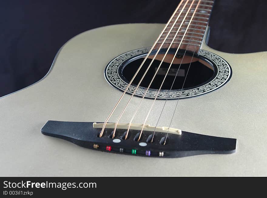 A silver acoustic guitar. A silver acoustic guitar.