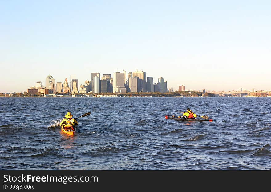 Photo of two kayakers with the Manhattan skyline in the background. Photo of two kayakers with the Manhattan skyline in the background