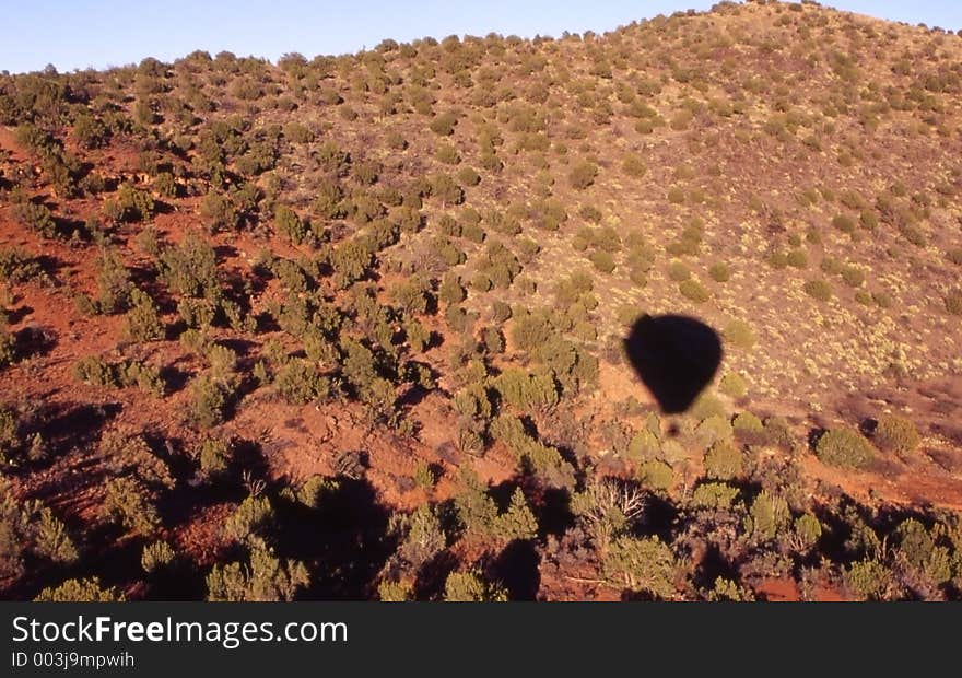 Hot air balloon shadow on the desert floor. Hot air balloon shadow on the desert floor.