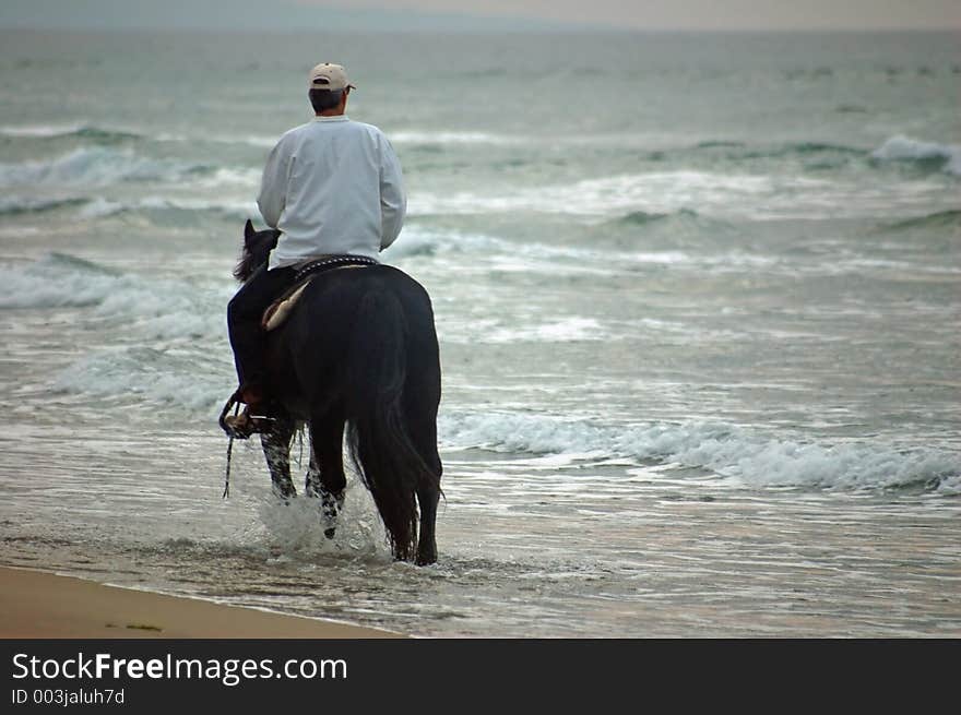 Riding into the sunset on the beach