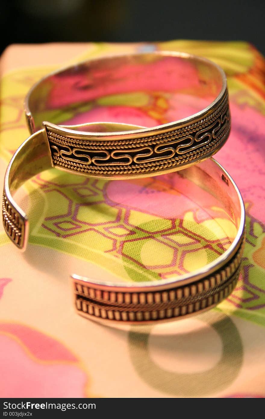 Close up view of 2 bangles against a pastel background