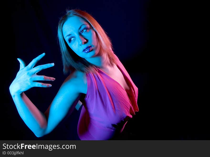 Woman in Pose shot with blue and pink filters and a wide angle lens