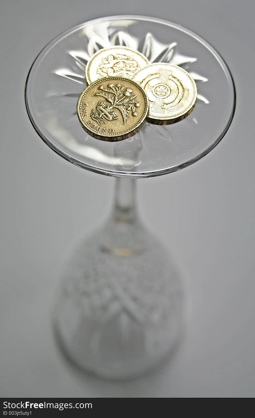 Britian coins on the base of a wine glass. Britian coins on the base of a wine glass