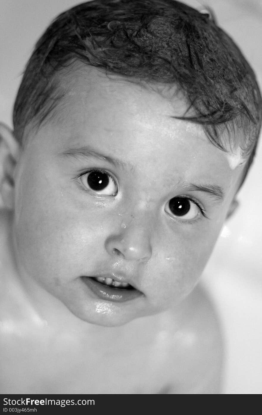 B&W photo of an adorable child in the bathtub