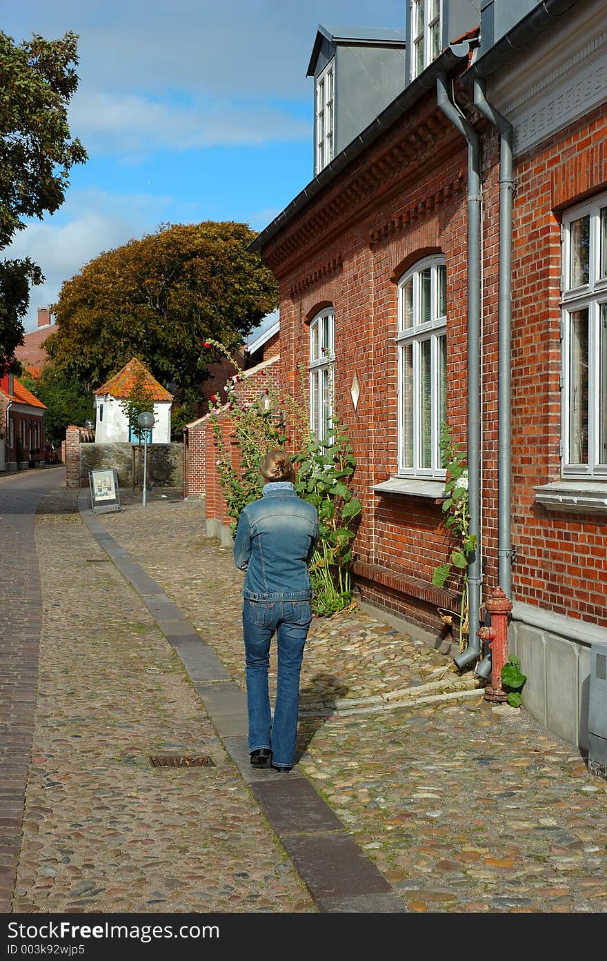 Woman walking down an old street. Woman walking down an old street