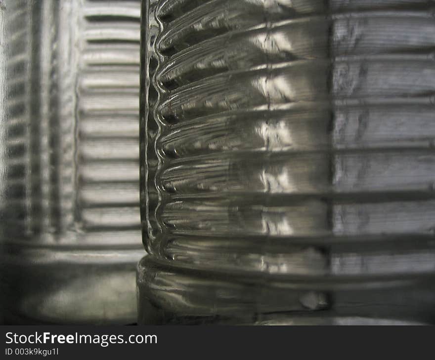 Close view of newly manufactured textured glass bottles with no (i.e. clear) tint. Close view of newly manufactured textured glass bottles with no (i.e. clear) tint.