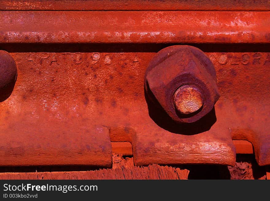 Close-up of a rusted bolt holding together a rusted railroad junction. Close-up of a rusted bolt holding together a rusted railroad junction.