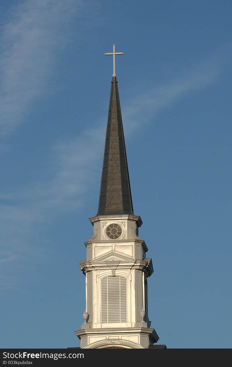 Church steeple against blue sky