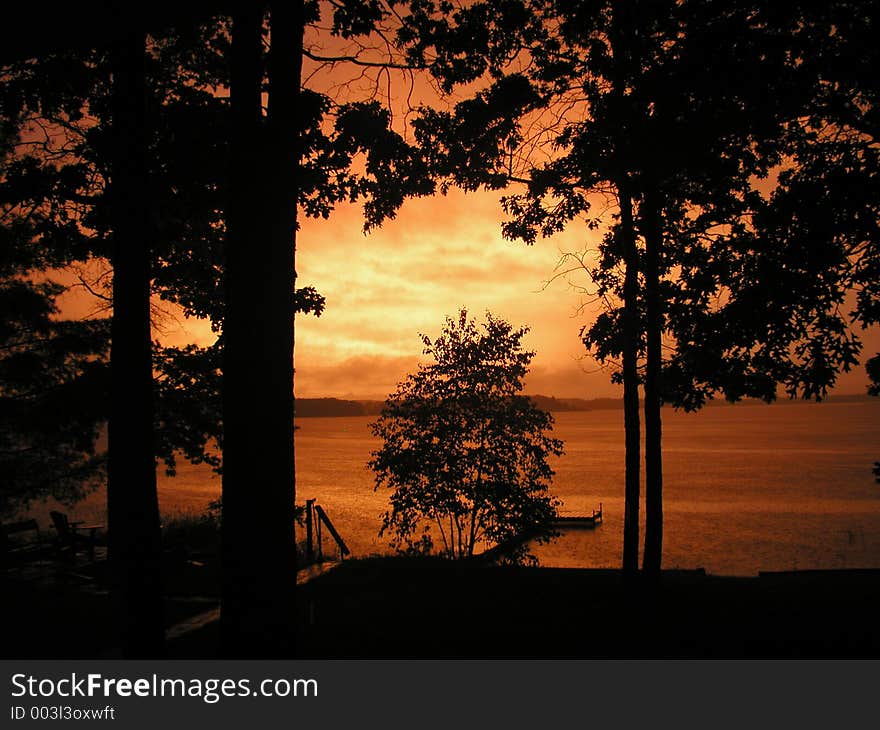 Vivid sunset on lake after a thunder storm. Vivid sunset on lake after a thunder storm.