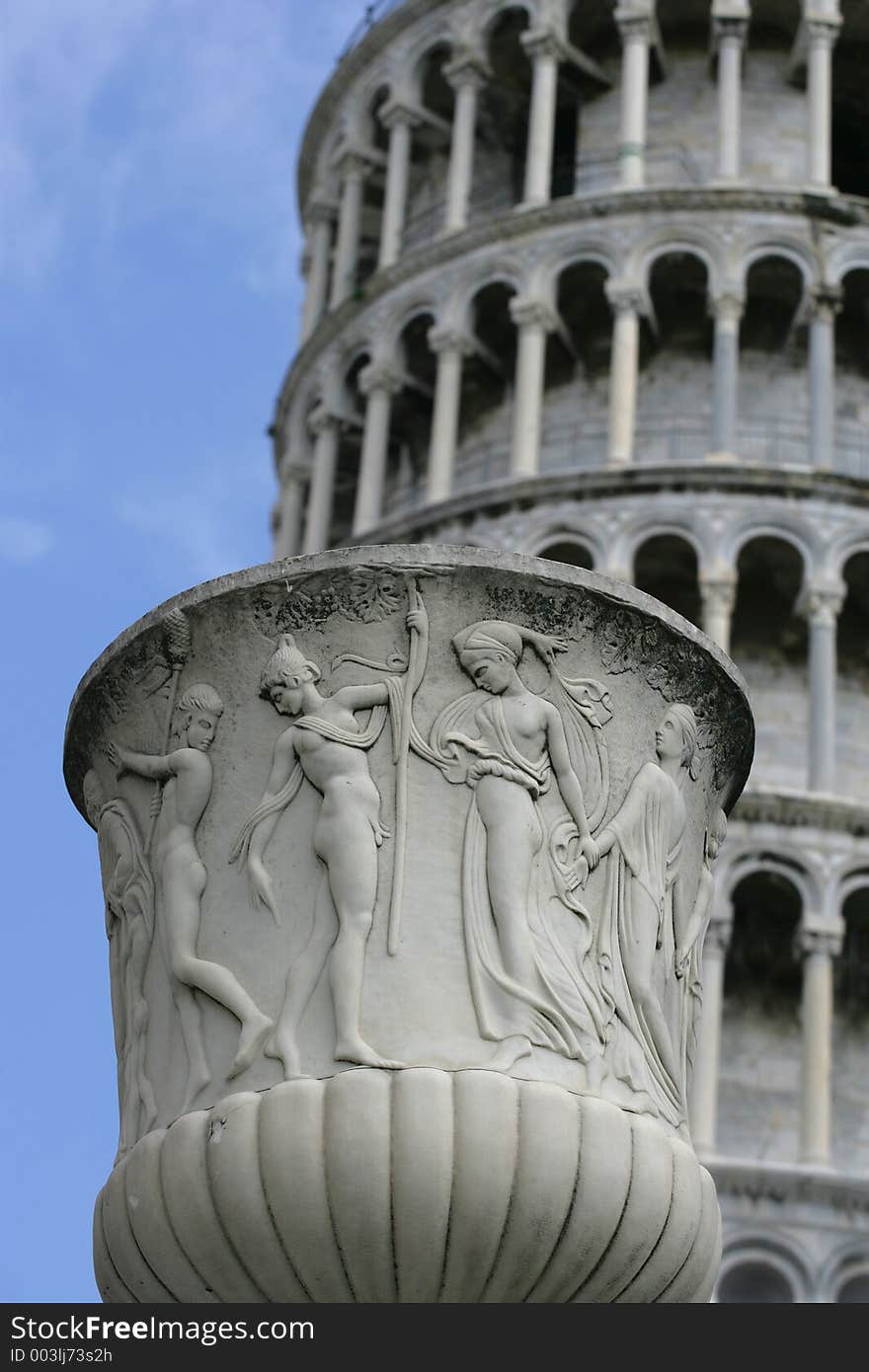 A pot in focus in front of the blurred Leaning Tower of Pisa. (9.5 x 14 image). A pot in focus in front of the blurred Leaning Tower of Pisa. (9.5 x 14 image)