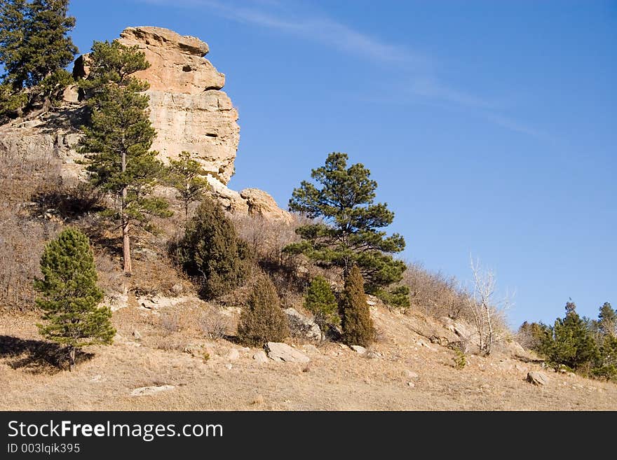 A granite rock formation in Castlewood Canyon State Park seems to take on the semblance of a face in profile overlooking a hiking trail. A granite rock formation in Castlewood Canyon State Park seems to take on the semblance of a face in profile overlooking a hiking trail.