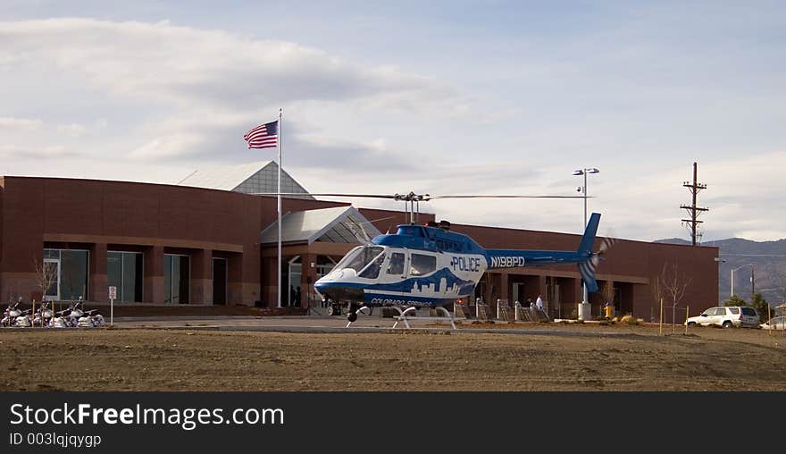 A blue and white police helicopter prepares to liftoff from a helo pad in front of a police substation in Colorado Springs. A blue and white police helicopter prepares to liftoff from a helo pad in front of a police substation in Colorado Springs