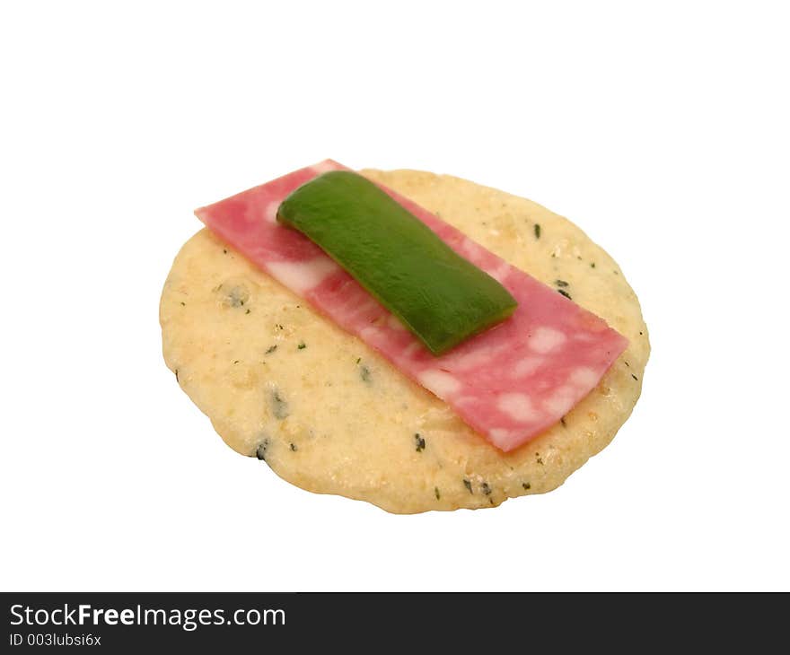 A chip,a little piece of salami and a piece of green pepper-a special snack sandwich-isolated over white background. A chip,a little piece of salami and a piece of green pepper-a special snack sandwich-isolated over white background