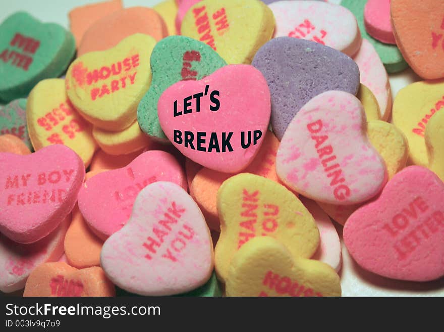 Candy hearts with sayings; pink middle heart says Let's Break Up. Candy hearts with sayings; pink middle heart says Let's Break Up.