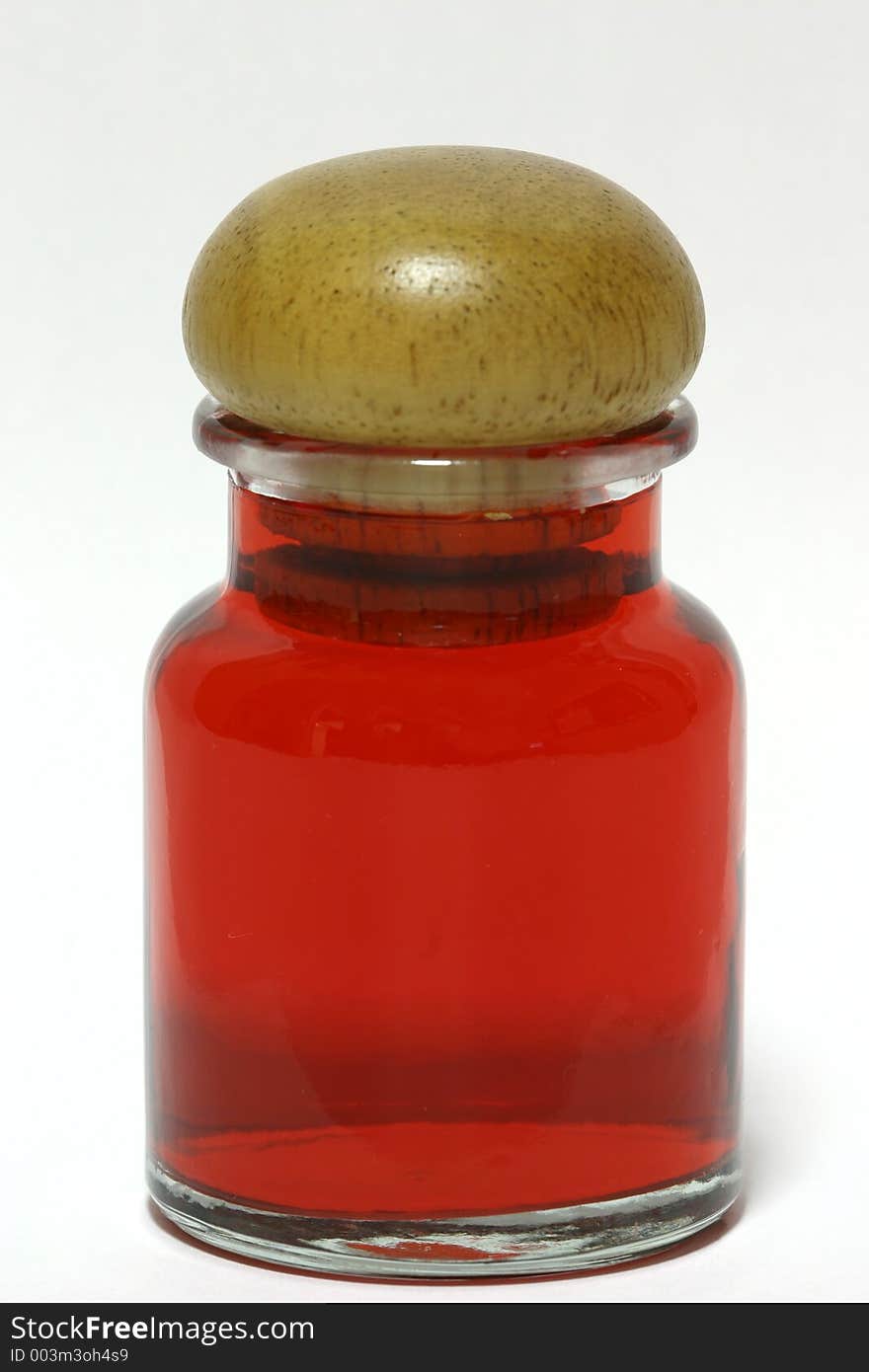 A bottle of red liquid