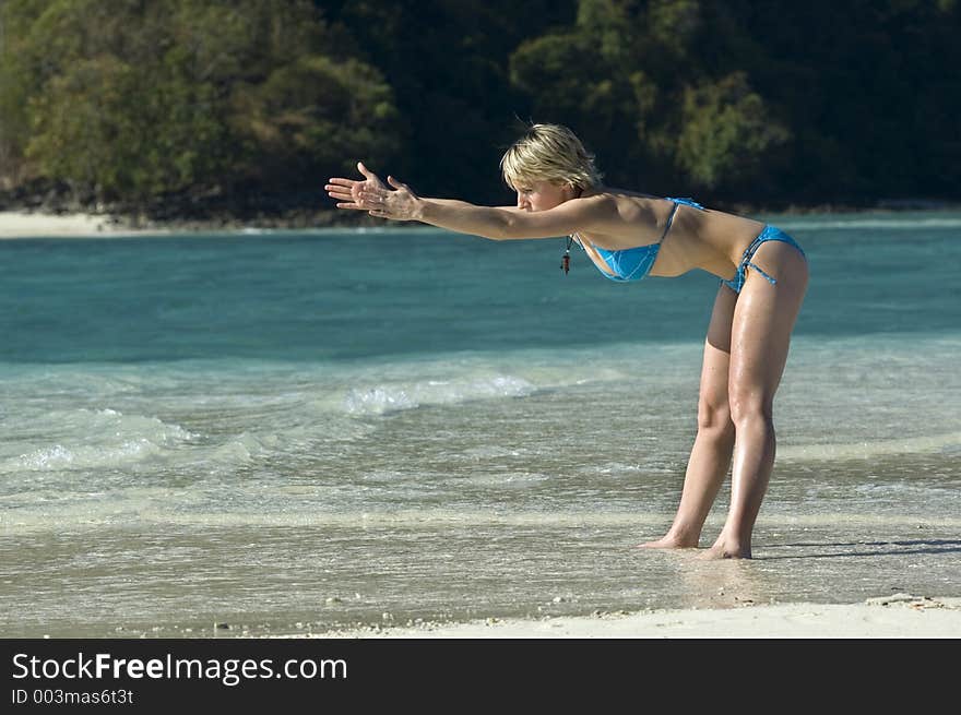 Girl stretching on the beach. Girl stretching on the beach