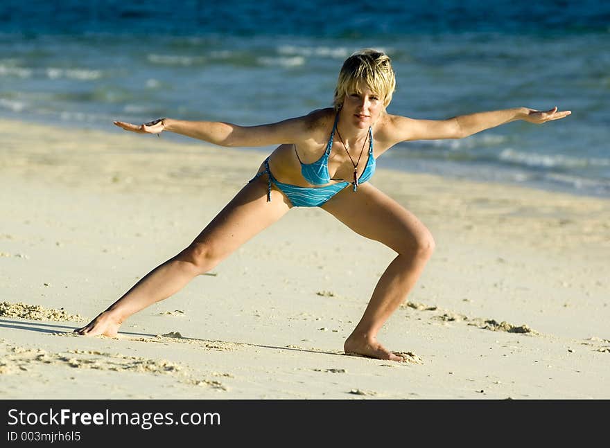 Girl stretching on the beach. Girl stretching on the beach