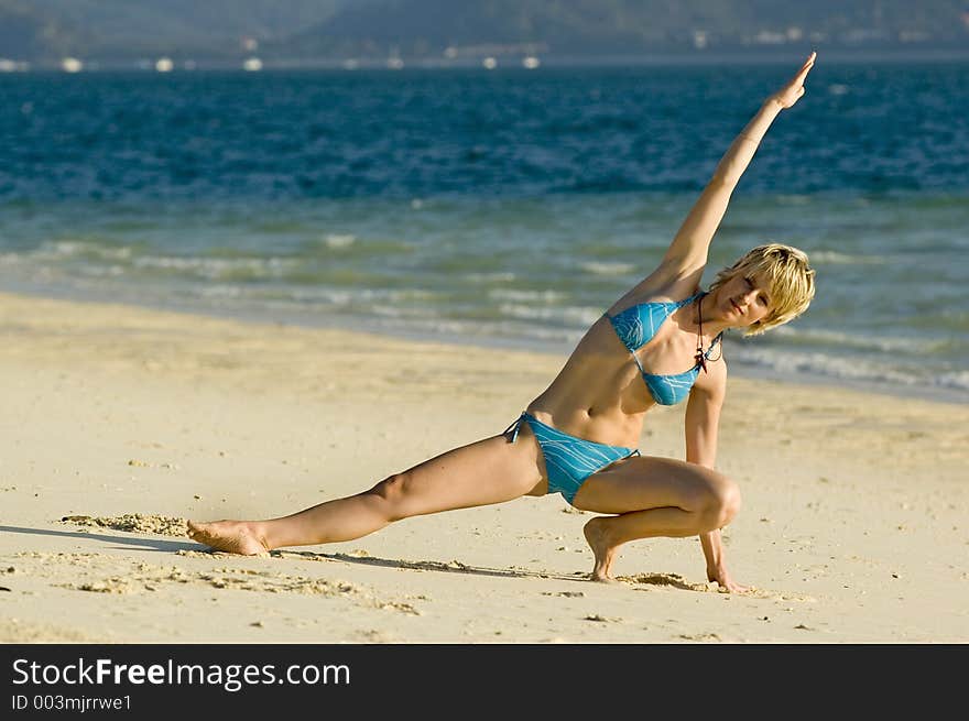 Girl stretching on the beach. Girl stretching on the beach