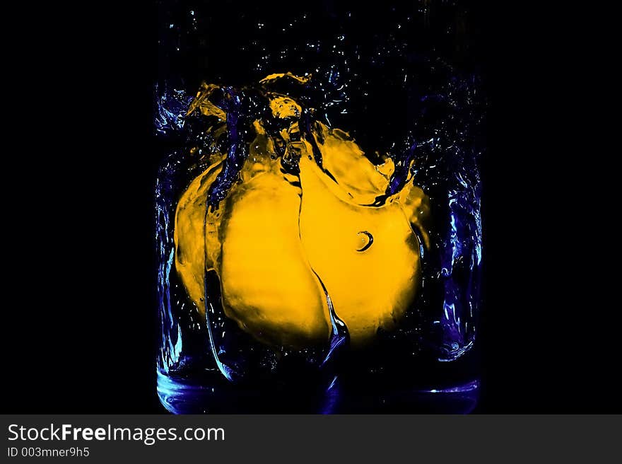 A lemon fallen in to a glass of water. A lemon fallen in to a glass of water