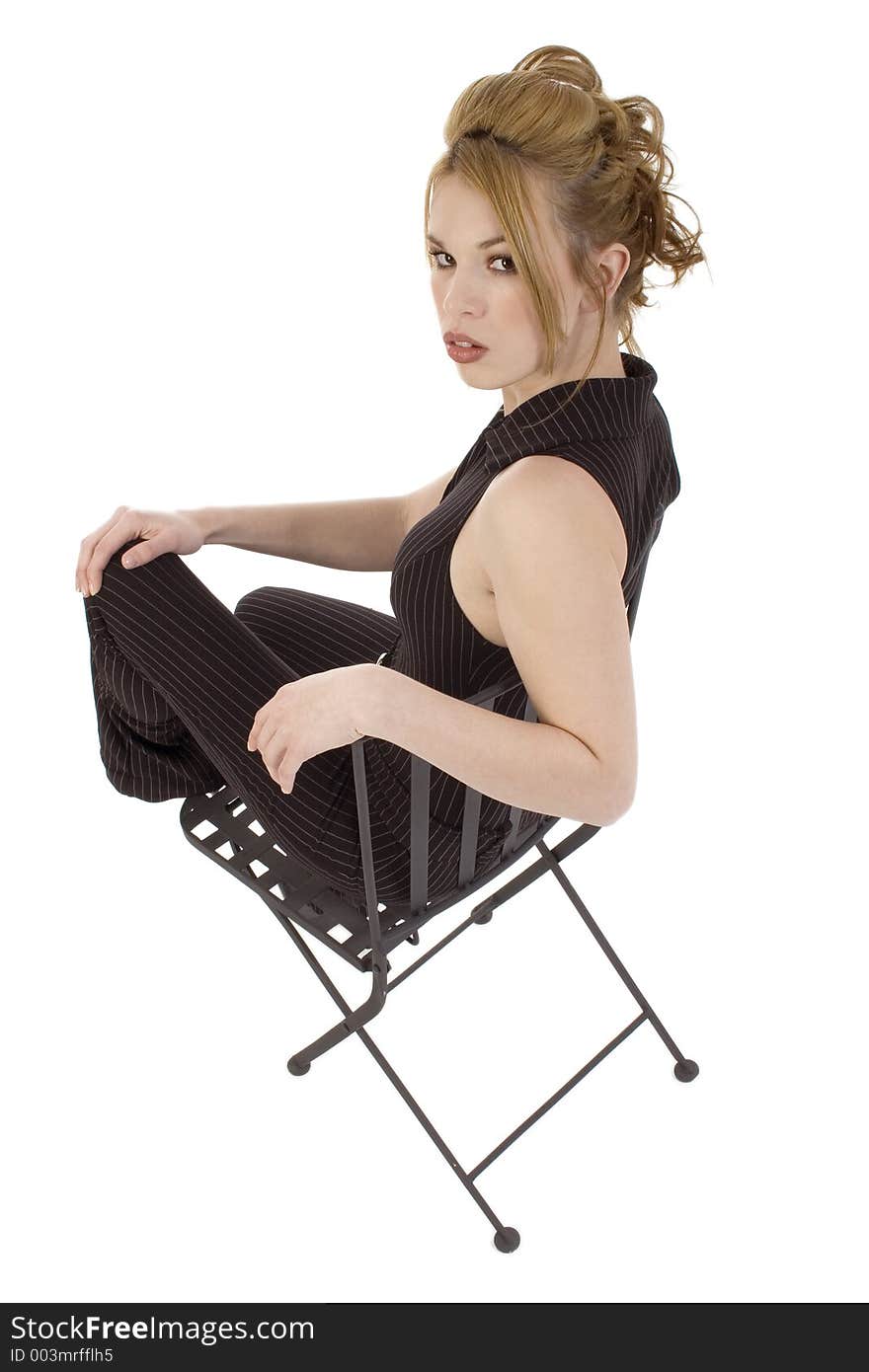 Glamorous Hispanic Woman in Black Iron Chair