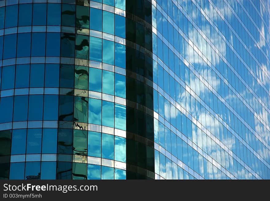 Cloudy sky reflected in glass of modern building. Cloudy sky reflected in glass of modern building