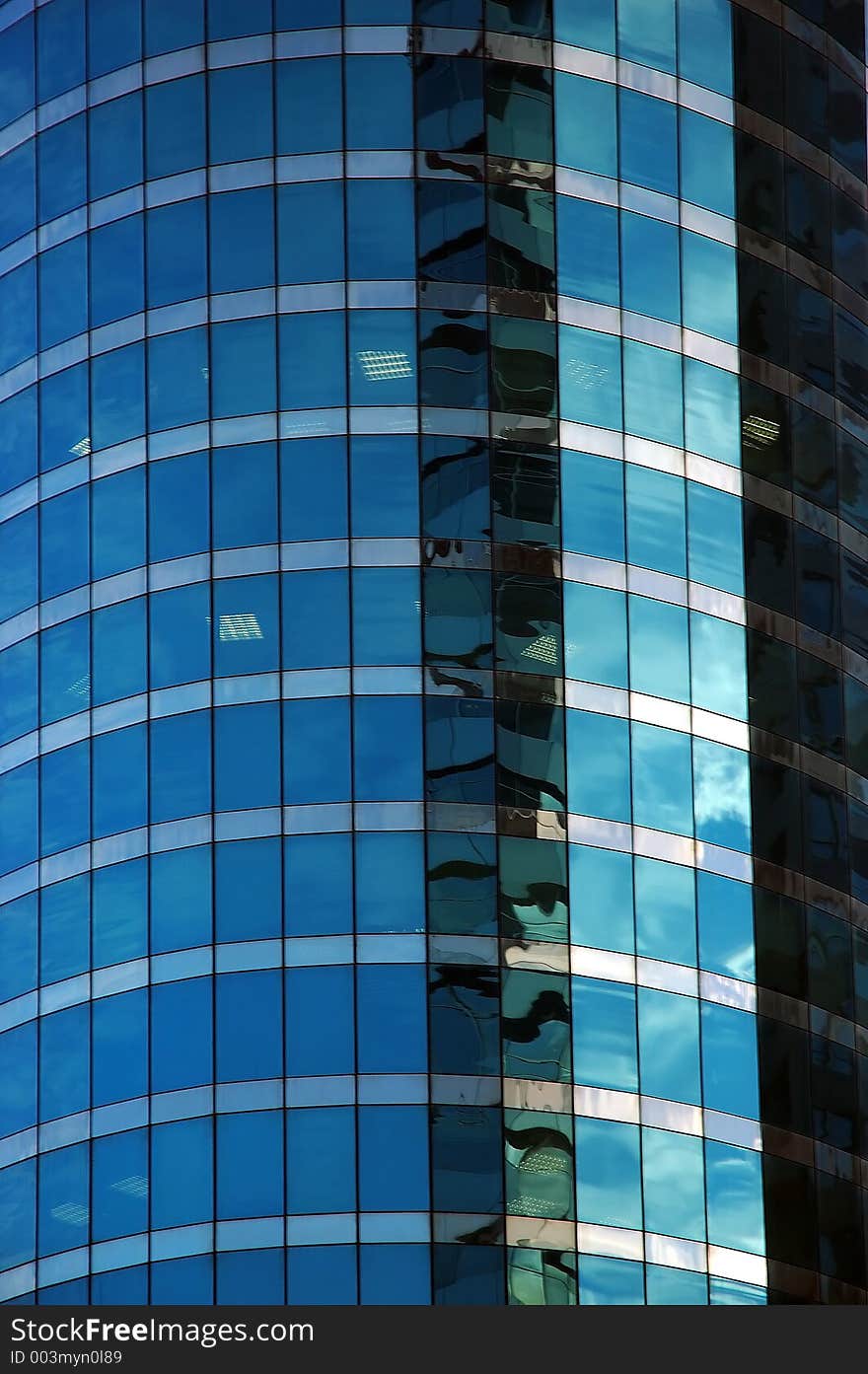 Cloudy sky reflected in glass of modern building. Cloudy sky reflected in glass of modern building