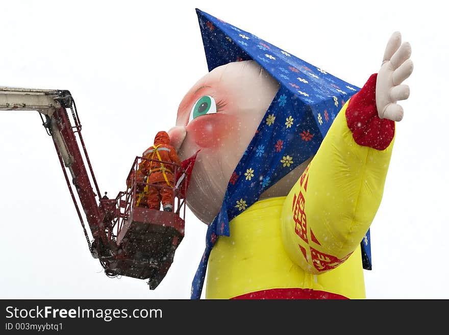 High-altitude workers in a blizzard mount a celebratory construction