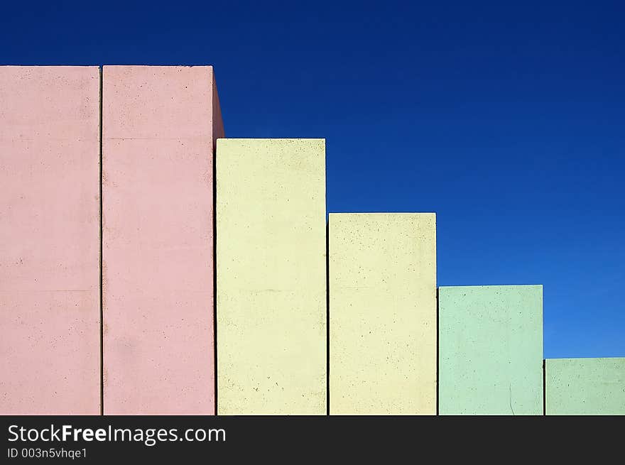 Concrete stairs shaped as chart on blue sky background colored from red to green. Concrete stairs shaped as chart on blue sky background colored from red to green