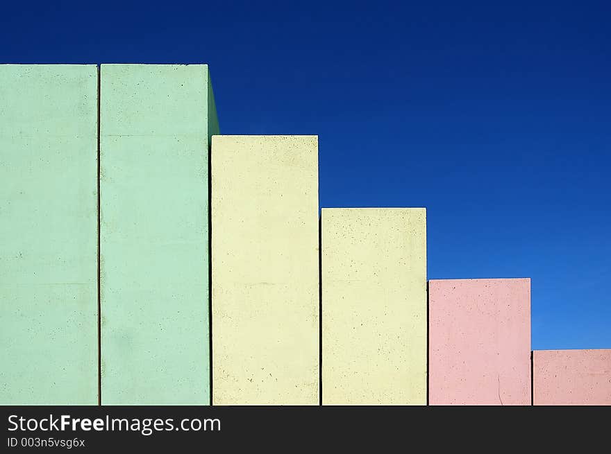 Concrete stairs shaped as chart on blue sky background colored from red to green. Concrete stairs shaped as chart on blue sky background colored from red to green