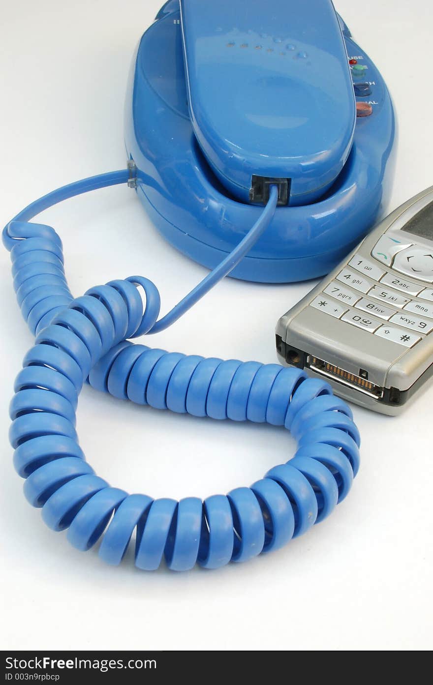 Blue telephone and mobile phone on white background. Blue telephone and mobile phone on white background