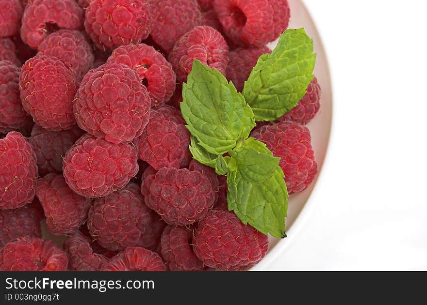 Bowl of raspberries with leaf. Bowl of raspberries with leaf