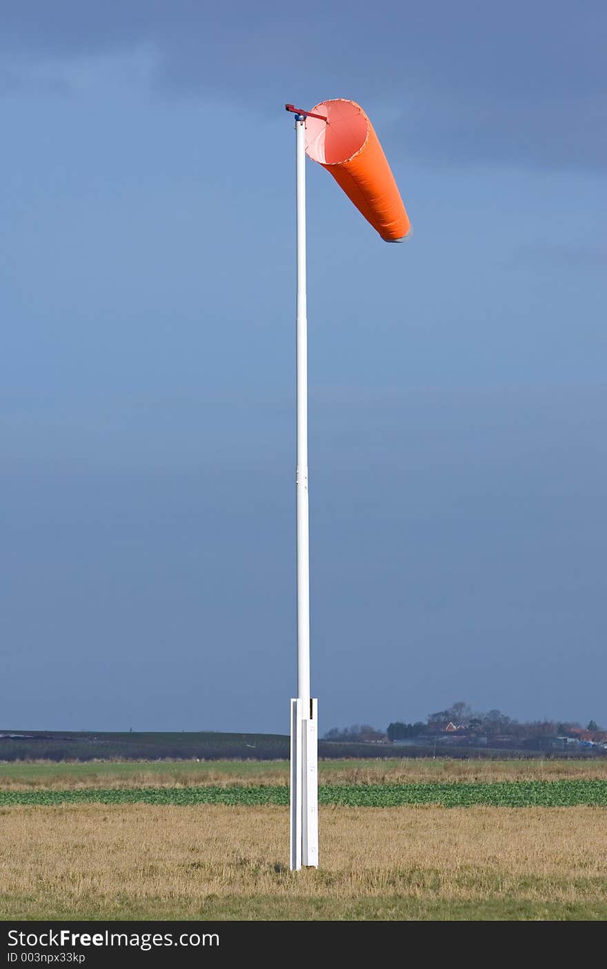 Wind sock in field of skydiving drop zone at Langar Airfield in Nottinghamshire on a dark, moody day