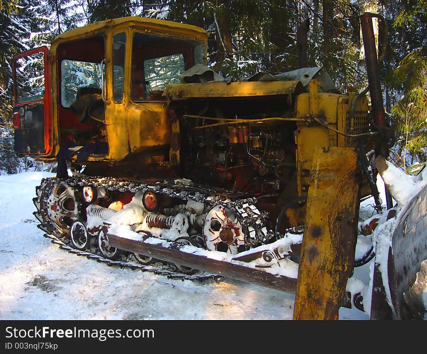 Old rusted catterpillar broken in the forest. Old rusted catterpillar broken in the forest