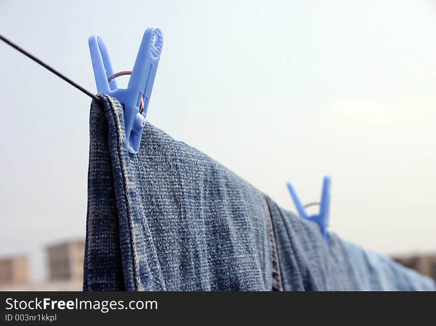 Clothesline with two pairs of jeans hanging. Clothesline with two pairs of jeans hanging