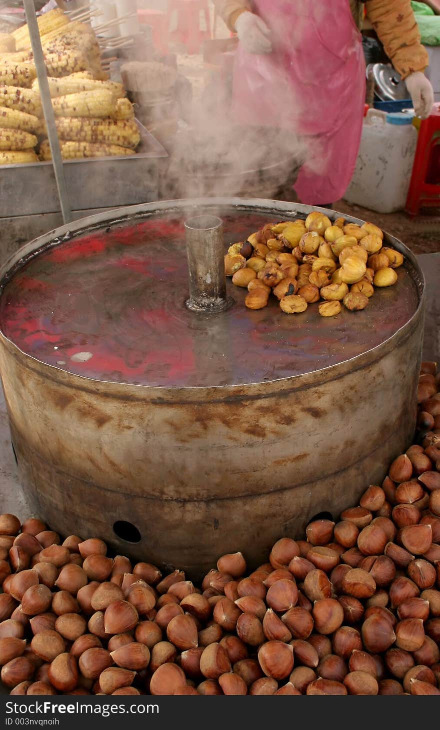 Roasted walnuts with a person in the background