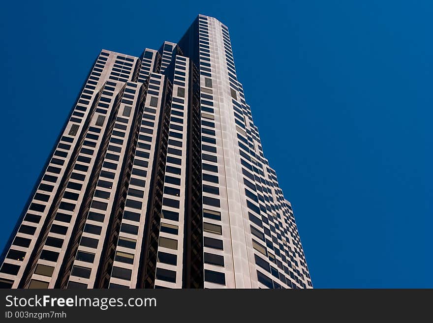 A skyscraper in San Francisco against a blue sky. A skyscraper in San Francisco against a blue sky