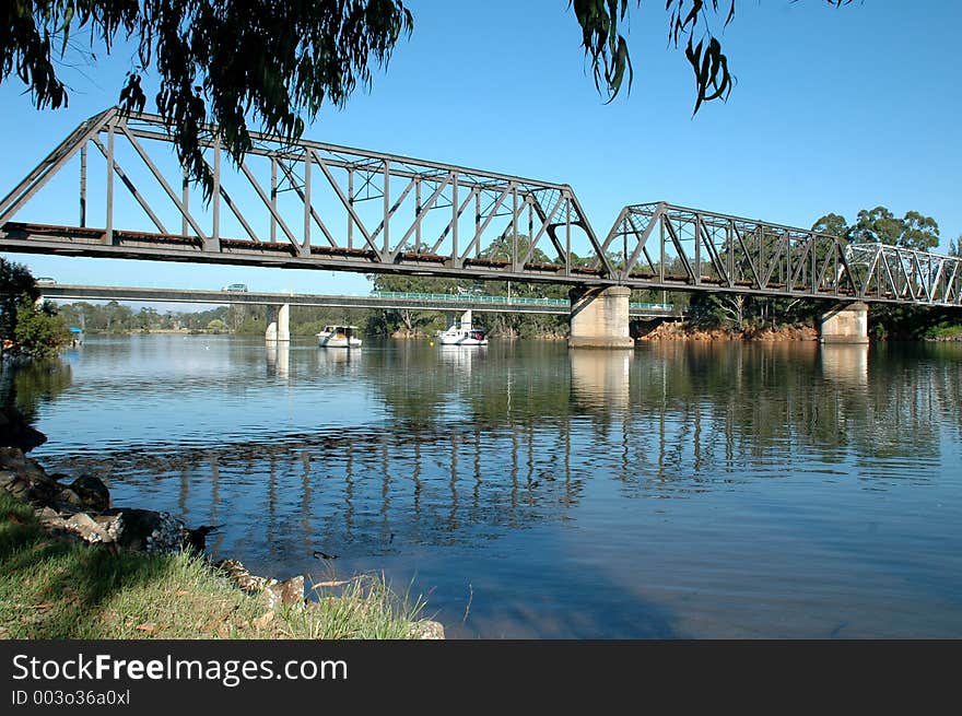 Boats Moored Under The Bridge