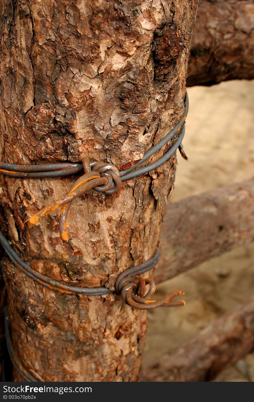 Old wooden fence post with rusty barbed wire. Old wooden fence post with rusty barbed wire