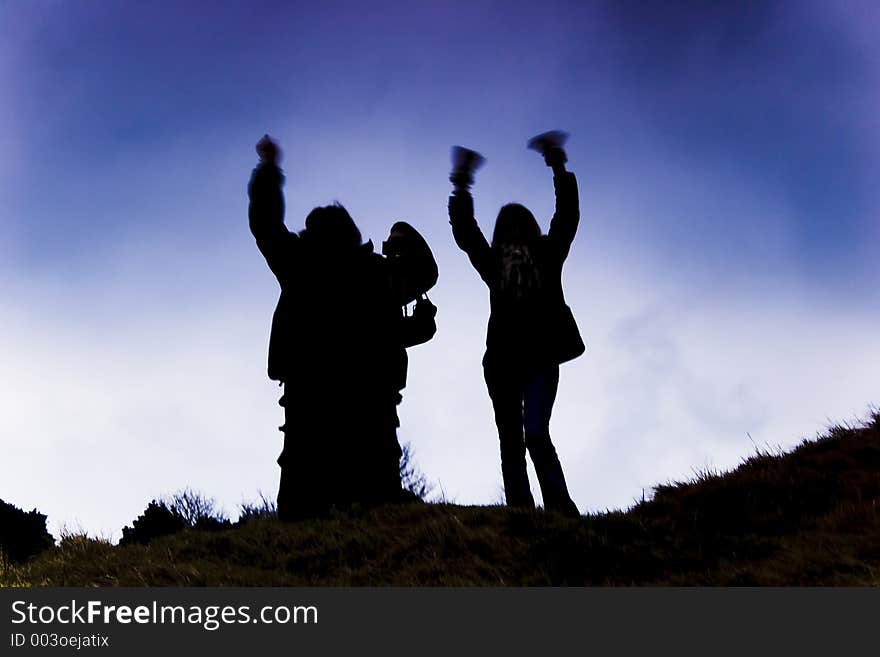 Two women silhouettes against the sky. Two women silhouettes against the sky